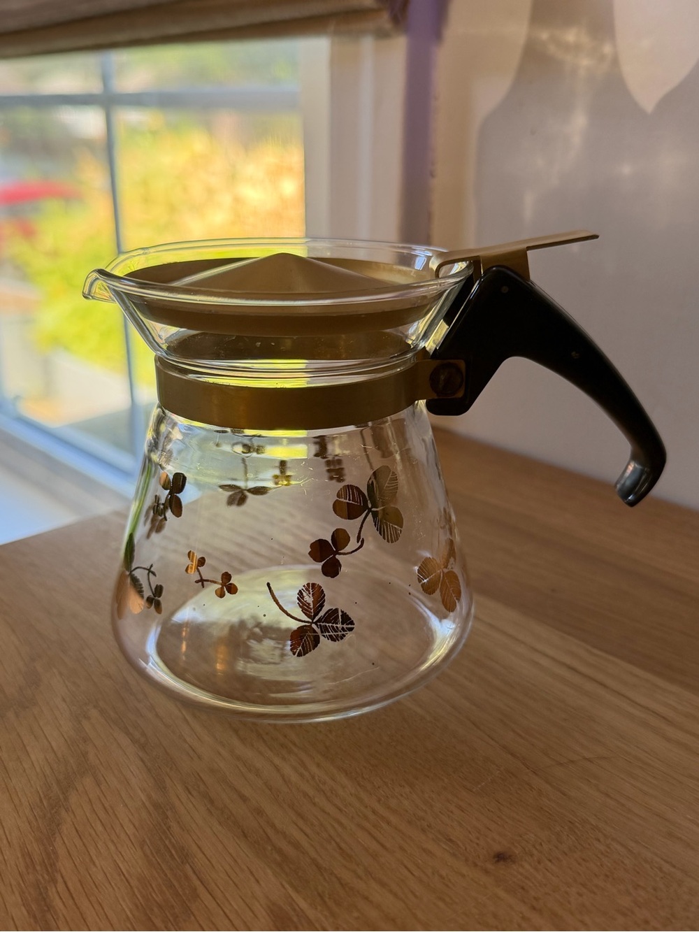 Glass Coffee Carafe with Gold Floral Accents and Black Handle